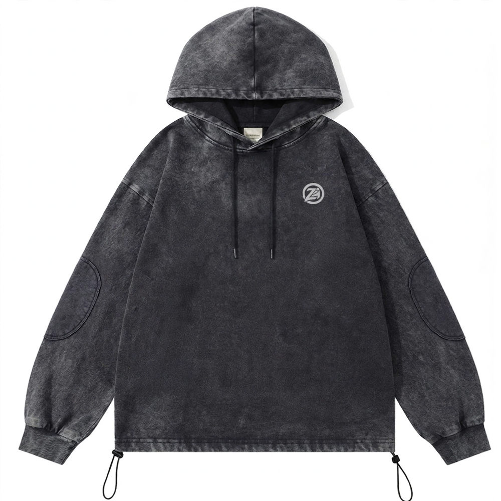 Charcoal grey acid wash oversized streetwear hoodie with drawstrings, minimalist chest graphic, ribbed cuffs, elbow panel detailing, and adjustable hem cords on a white background.