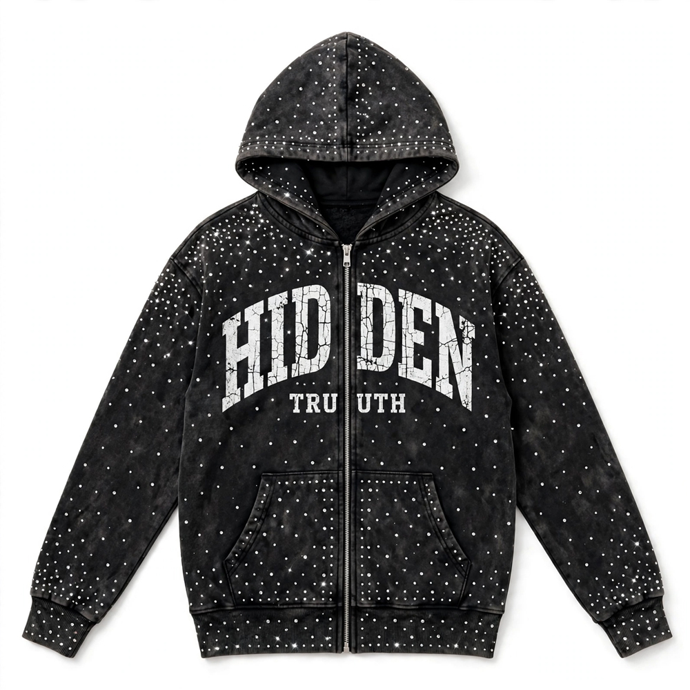 Black acid-wash zip-up hoodie featuring sparkling rhinestone embellishments, distressed white front lettering, an adjustable hood, and ribbed cuffs.